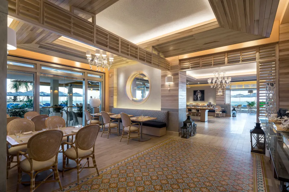 Bright restaurant interior with terrace access at Condado Vanderbilt Hotel.