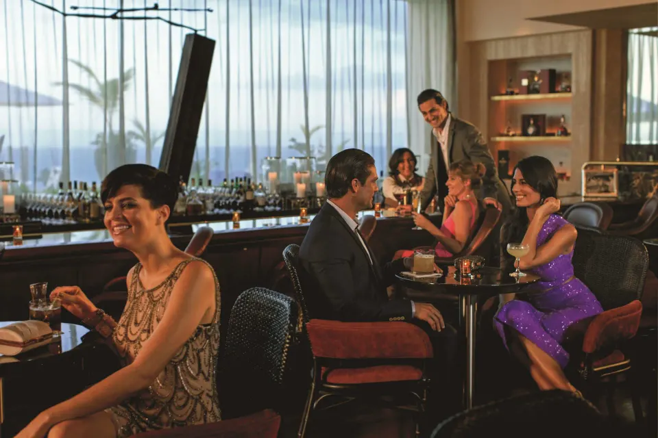 Guests seated in an ocean-view lounge at Condado Vanderbilt Hotel.