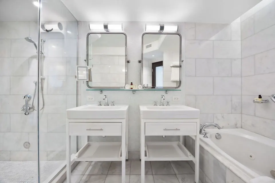 Twin-sink bathroom with bathtub and shower in the Biltmore Ocean View Suite at Condado Vanderbilt Hotel.