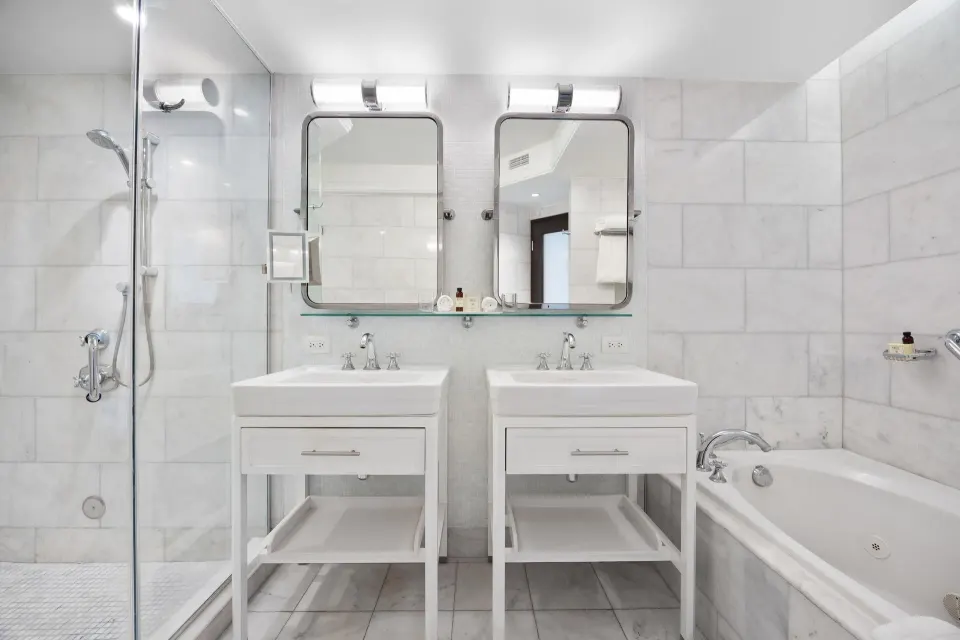 Bathroom with double vanities, shower, and tub in the Biltmore Ocean View Suite at Condado Vanderbilt Hotel.