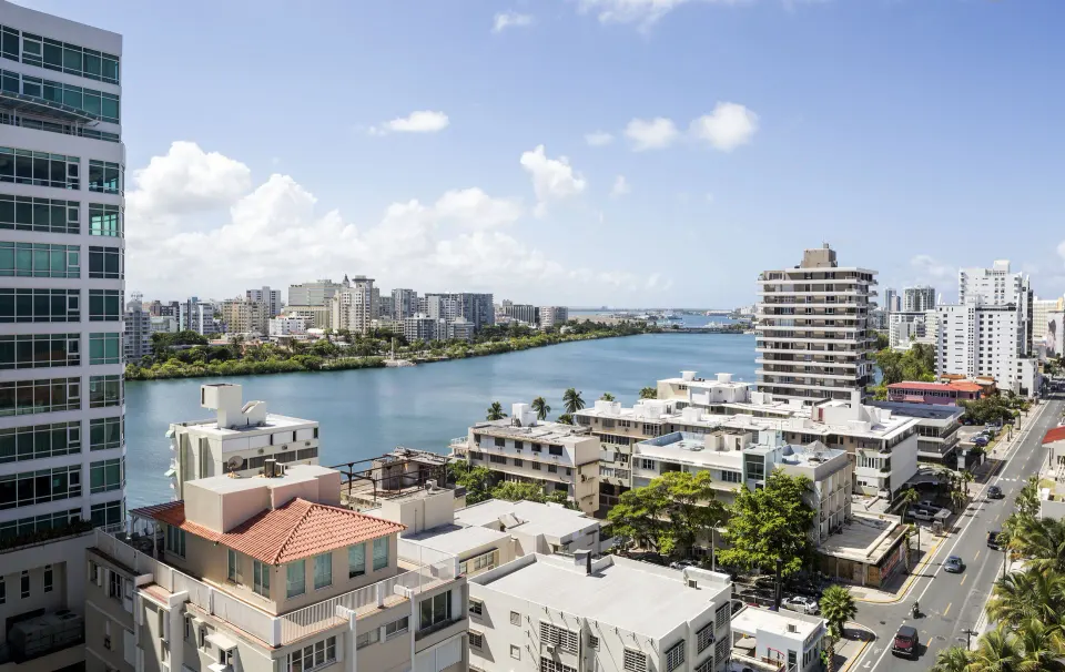 City and lagoon view from the Commodore City View One-Bedroom Suite at Condado Vanderbilt Hotel.