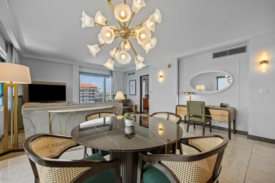 Living and dining area in the Commodore City View One-Bedroom Suite at Condado Vanderbilt Hotel.