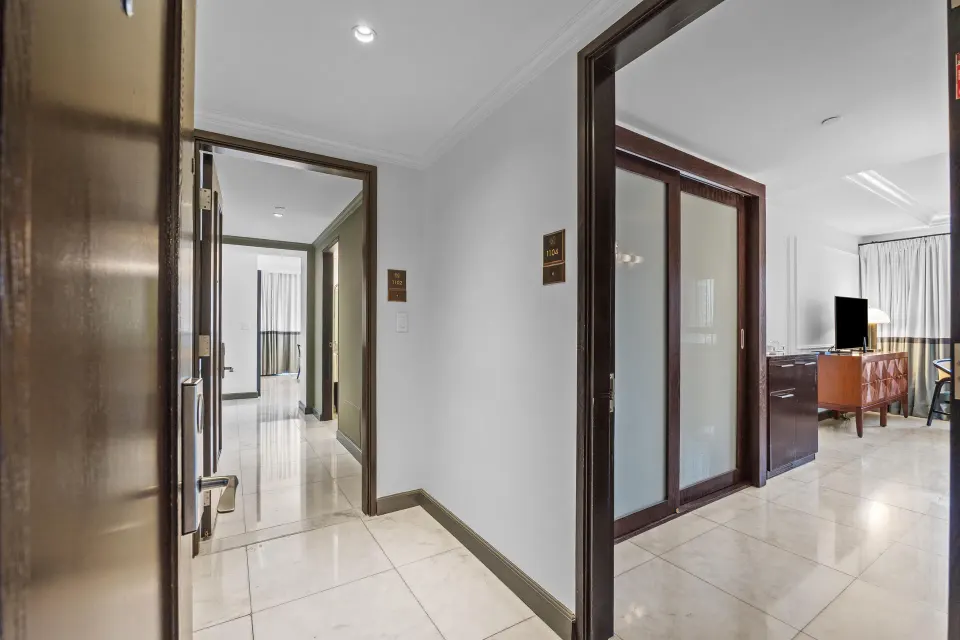 Entry hallway connecting rooms in the Commodore City View Two-Bedroom Room at Condado Vanderbilt Hotel.