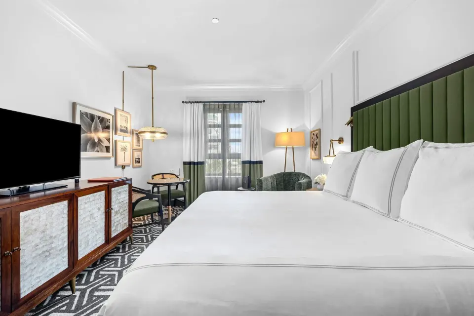 Heritage King Room with king bed and green headboard at Condado Vanderbilt Hotel.