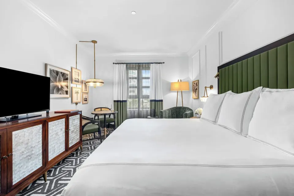 Heritage King Room with white king bed and seating area at Condado Vanderbilt Hotel.
