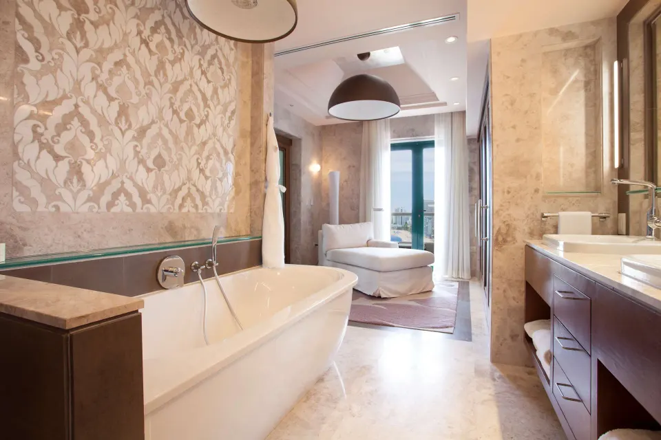 Soaking tub and vanity in the Vanderbilt Oceanfront Two-Bedroom Suite at Condado Vanderbilt Hotel.
