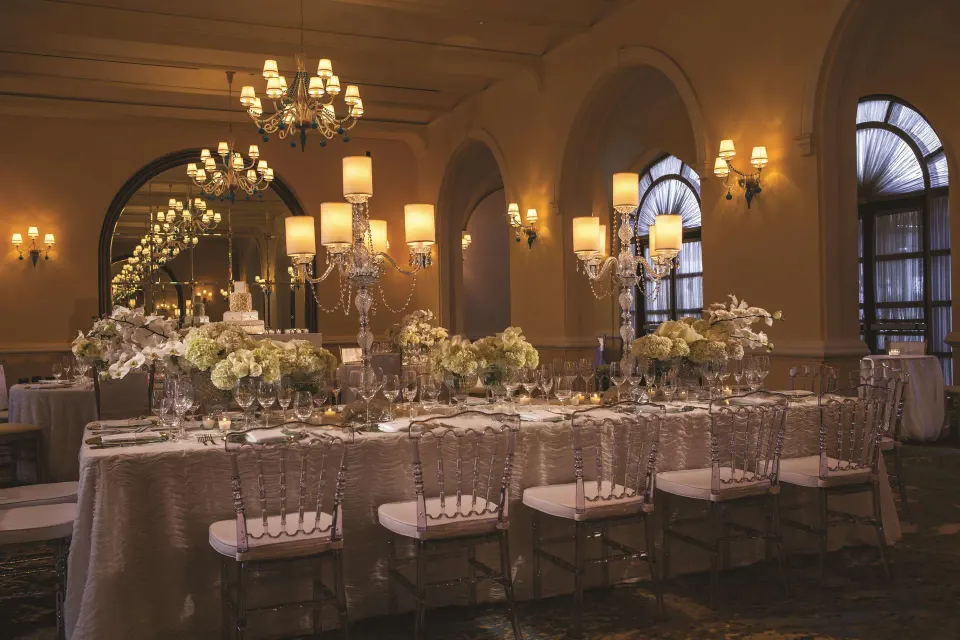 Elegant event table with floral centerpieces at Condado Vanderbilt Hotel.