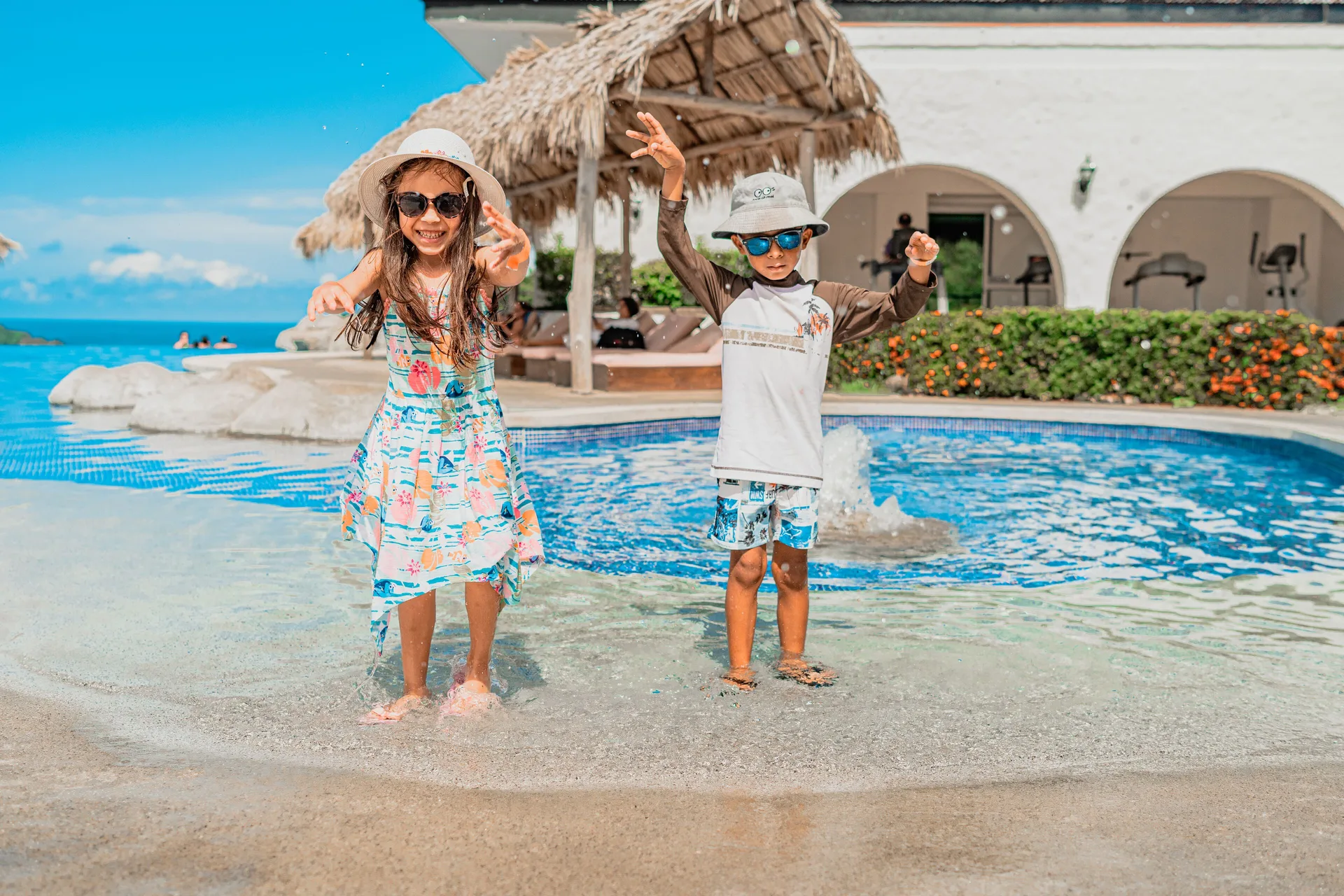 Two children standing in a shallow pool area at Condovac la Costa.