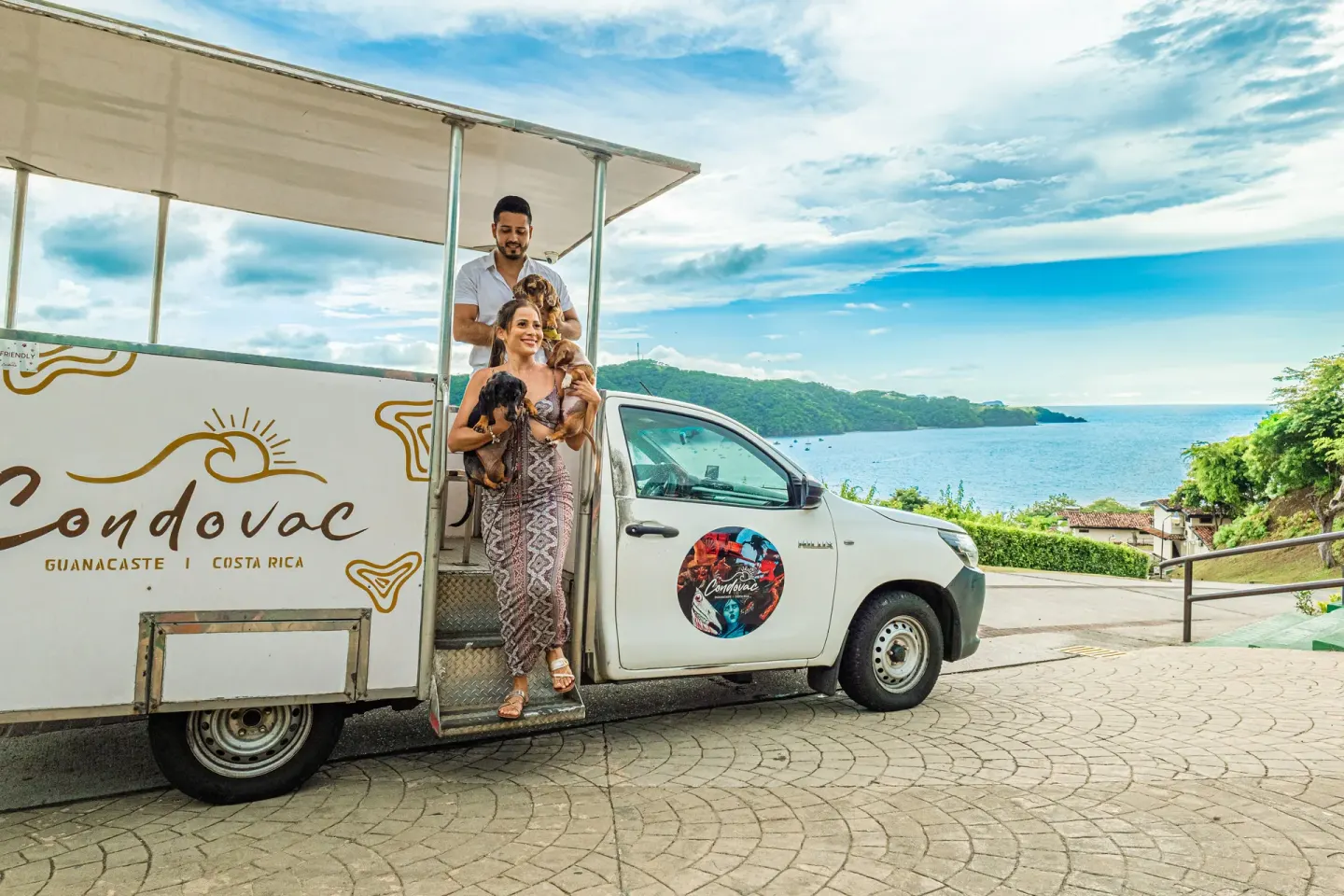 Guests with dogs step from a Condovac vehicle with bay views at Condovac la Costa.
