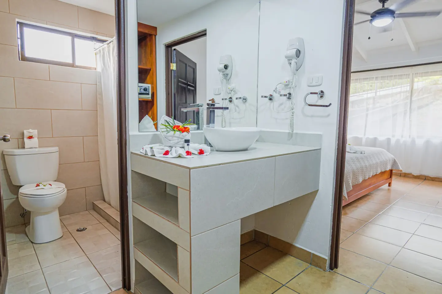 Family Suite bathroom vanity and shower beside bedroom at Condovac la Costa.