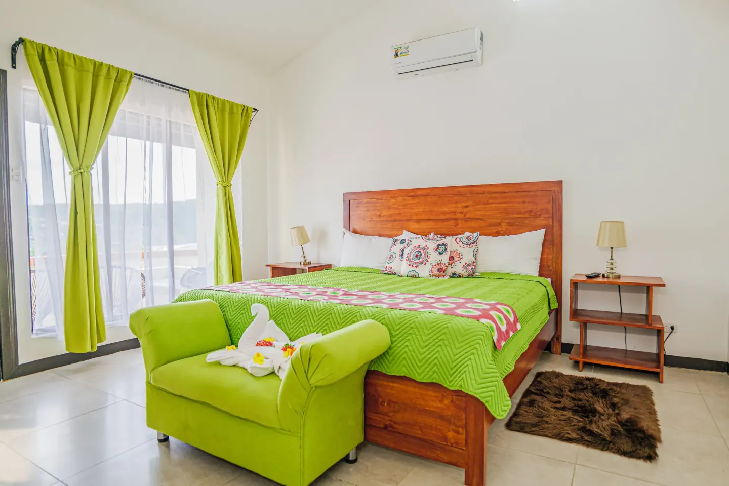 Family Suite bedroom with king bed and green accents at Condovac la Costa.
