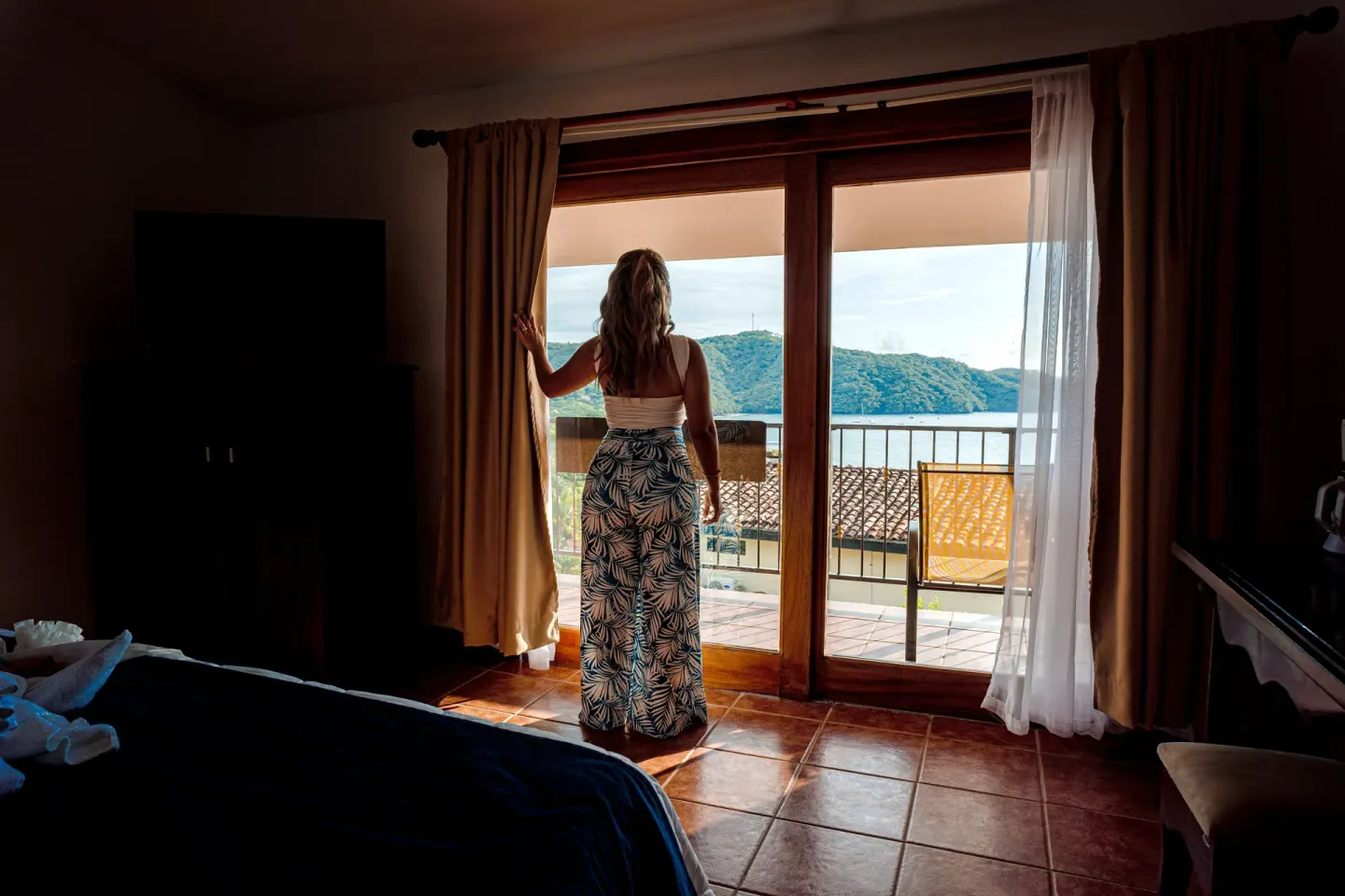 Romantic Studio Suite at Condovac la Costa with balcony doors framing a bay view.
