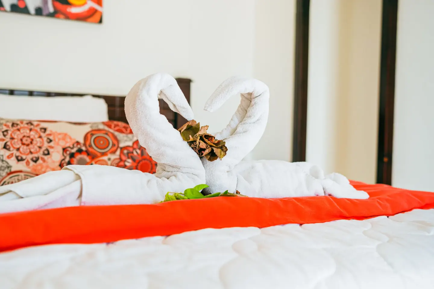 Romantic Studio Suite at Condovac la Costa with towel swans arranged on the bed.