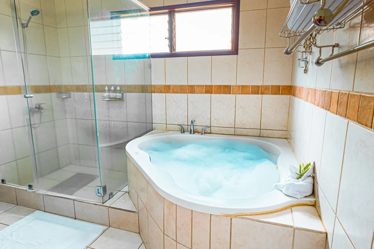 Romantic Studio Suite at Condovac la Costa with a soaking tub and glass shower.