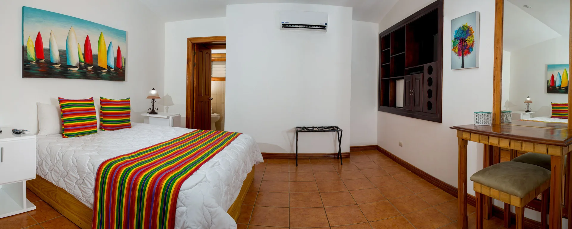 Villa Platinum Ocean View bedroom with striped bedding at Condovac la Costa.