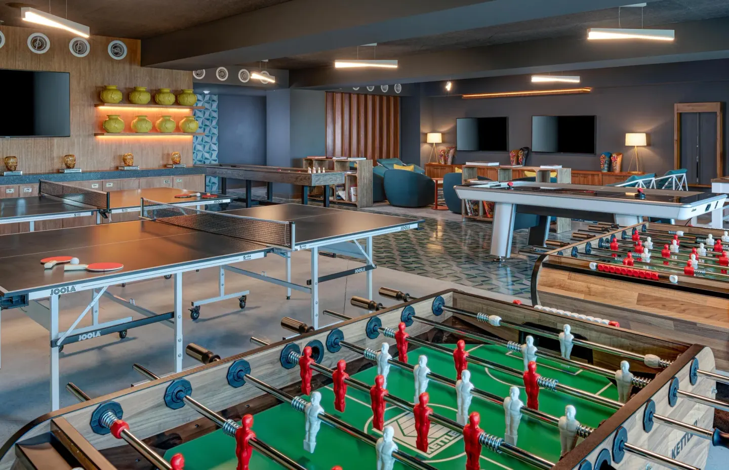 Indoor game room with foosball, ping-pong, billiards, and lounge seating at Conrad Punta de Mita.