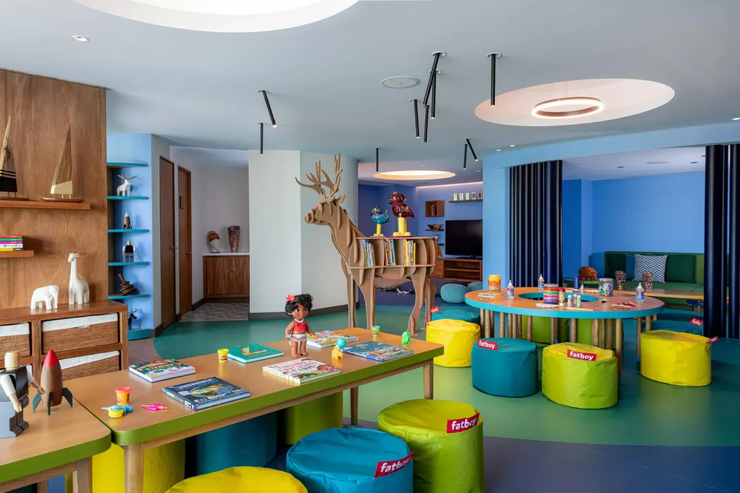 Colorful kids club playroom with tables, toys, and beanbag seats at Conrad Punta de Mita.