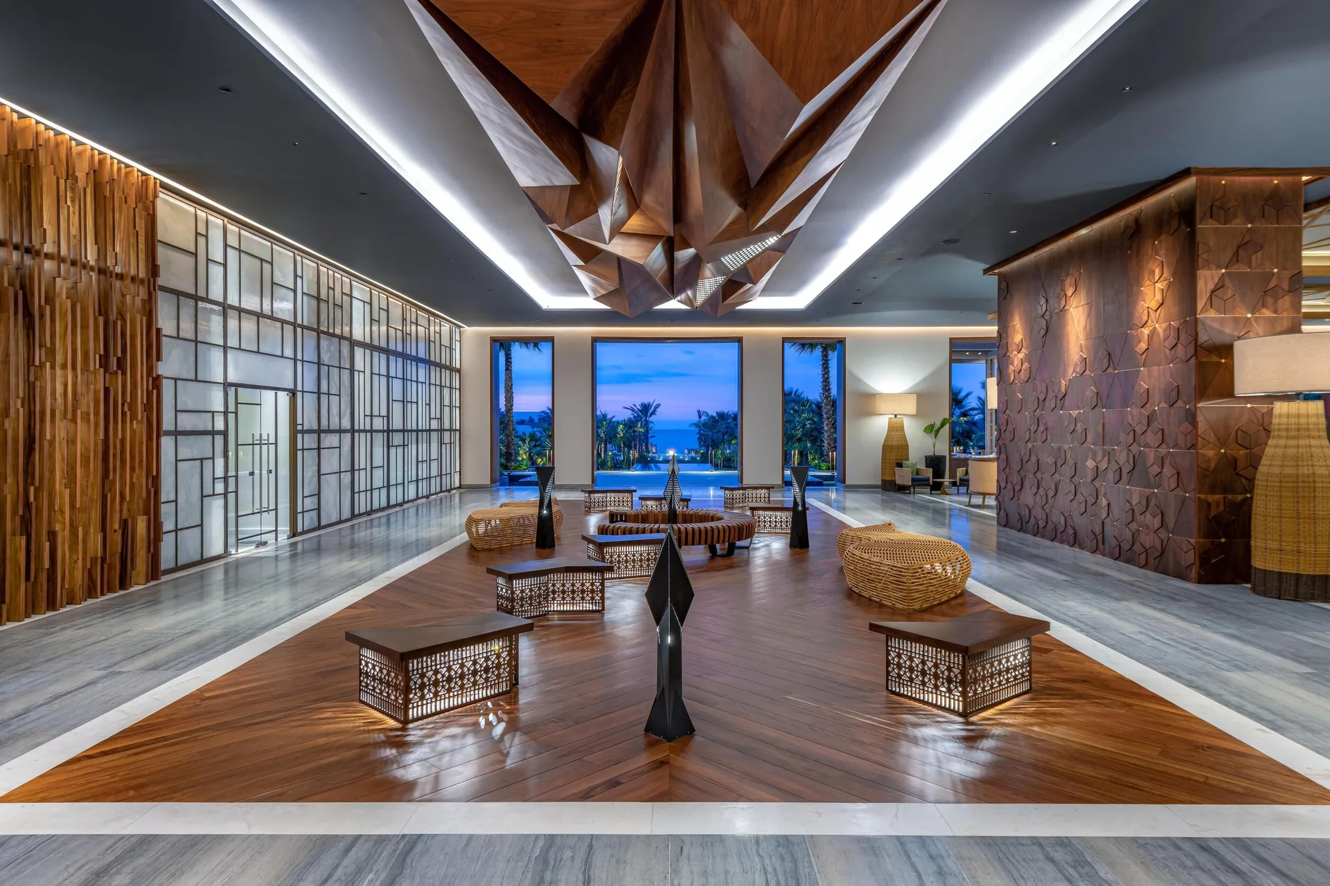 Spacious lobby with sculptural ceiling, patterned screens, and ocean view at Conrad Punta de Mita.