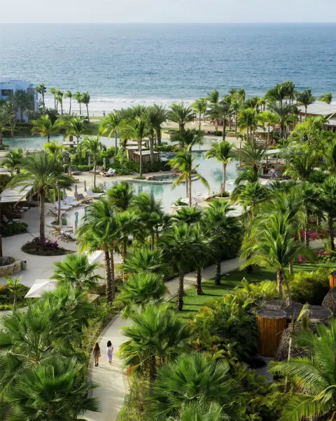 Aerial view of pools, palms, paths and the ocean at Conrad Punta de Mita.