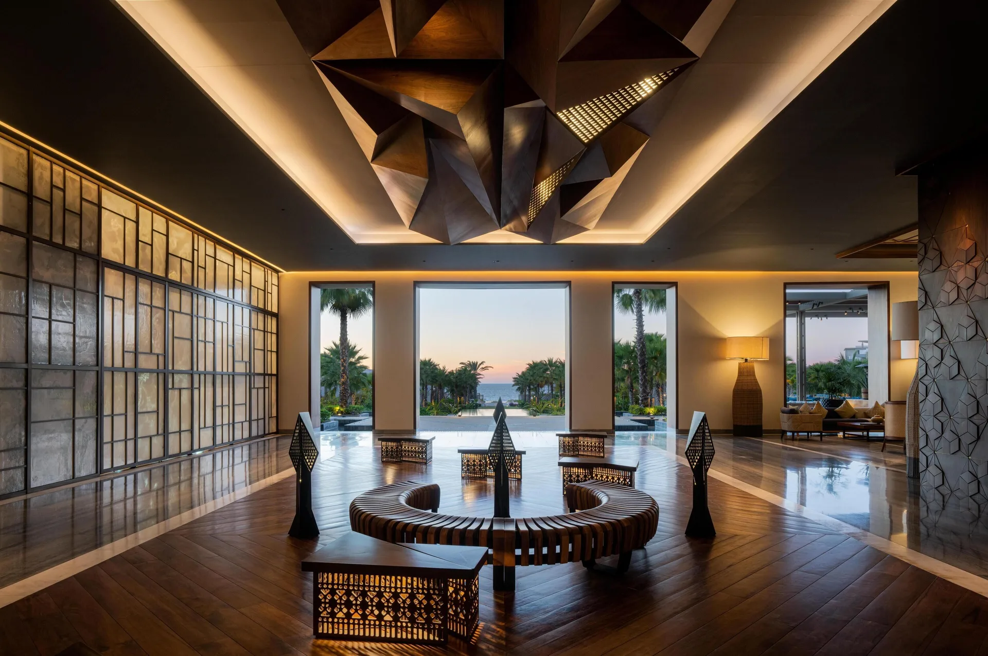 Lobby seating beneath a geometric ceiling feature at sunset at Conrad Punta de Mita.