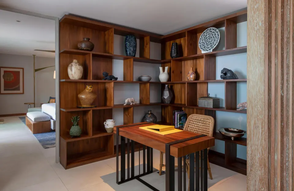 Penthouse study with wood shelving and writing desk at Conrad Punta de Mita.