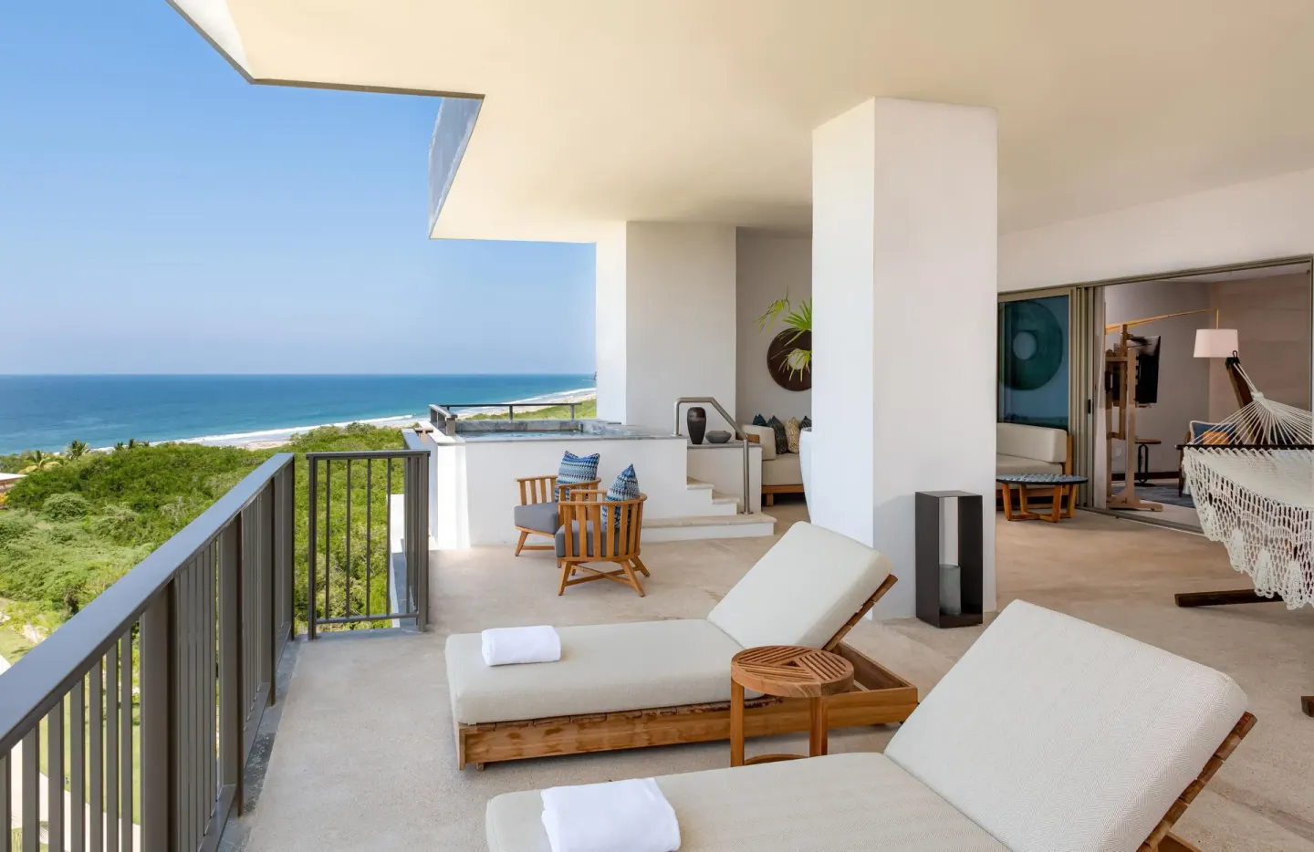Penthouse balcony with ocean view and loungers at Conrad Punta de Mita.