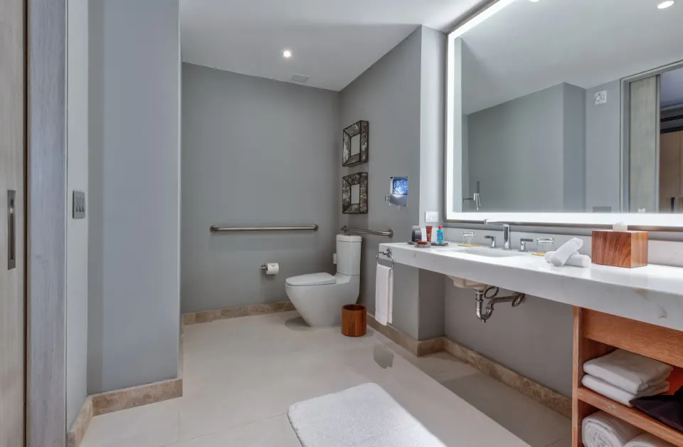 Accessible bathroom with vanity and grab bars at Conrad Punta de Mita.