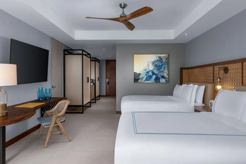 Two-bed accessible room with desk and wardrobe area at Conrad Punta de Mita.