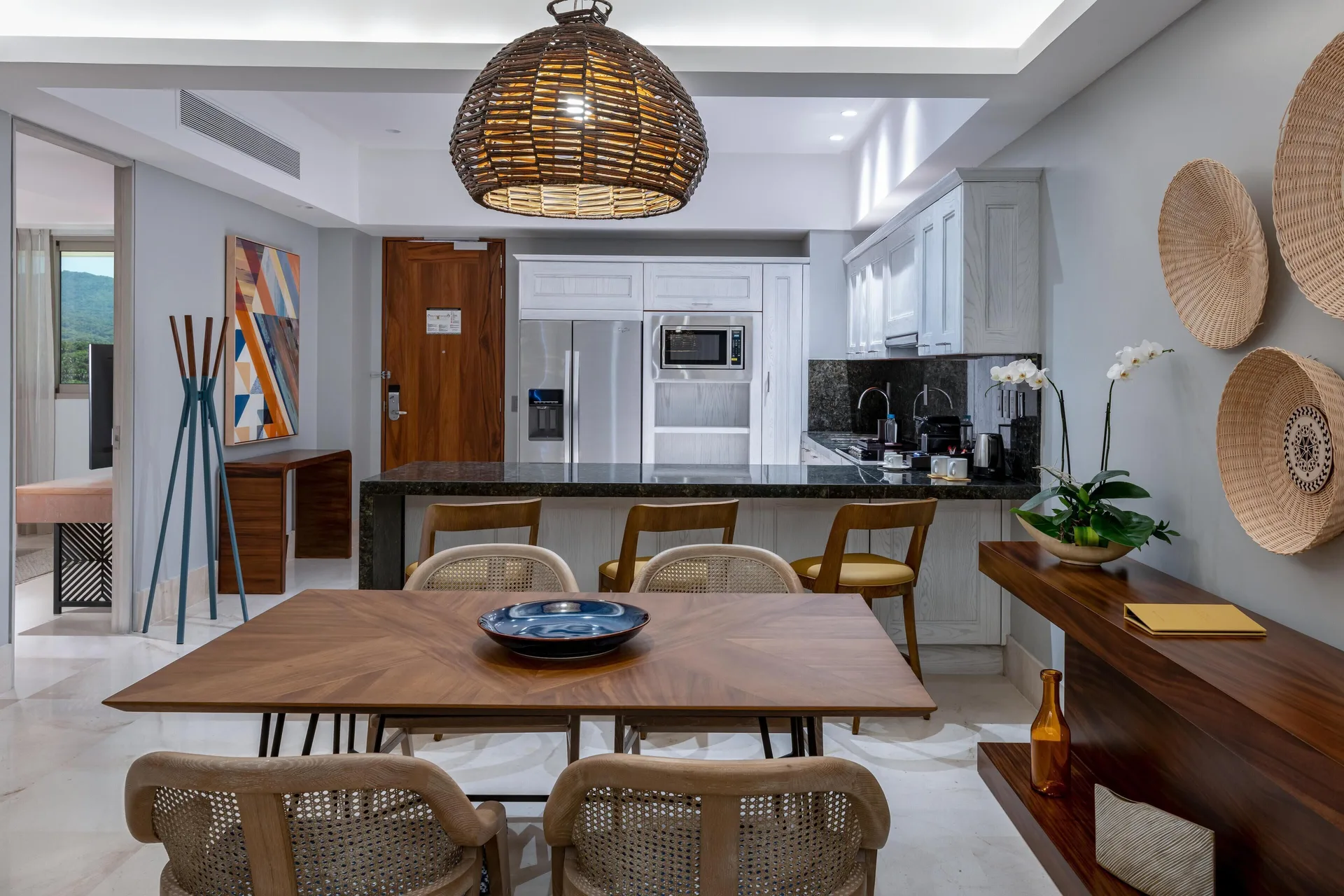 Kitchen and dining area in a two-bedroom ocean-view suite at Conrad Punta de Mita with bar seating.