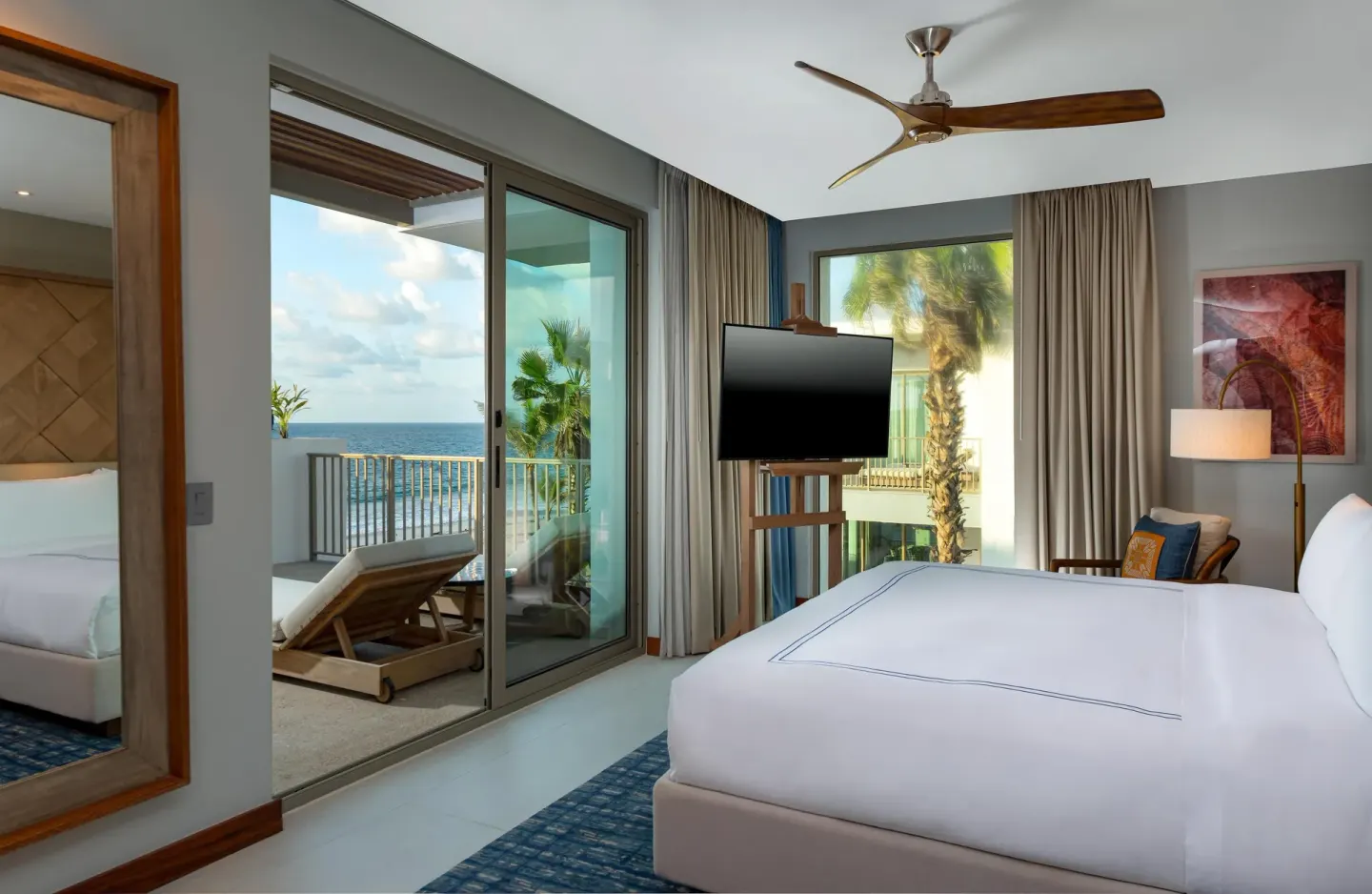 Oceanfront suite bedroom with balcony and sea view at Conrad Punta de Mita.