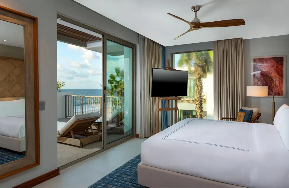 Oceanfront suite bedroom with balcony and sea view at Conrad Punta de Mita.