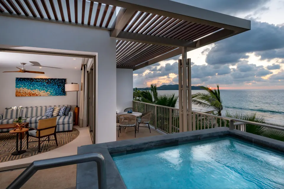 Oceanfront suite private pool at sunset with living room and sea view at Conrad Punta de Mita.