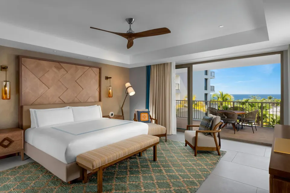 Superior Suite Ocean View king bedroom with balcony and ocean beyond at Conrad Punta de Mita.