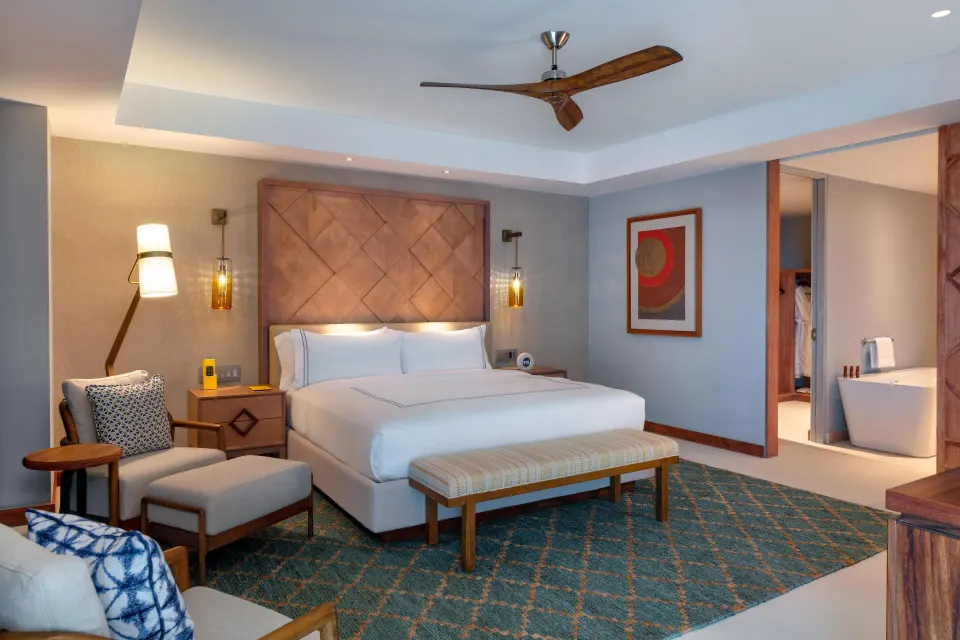 Superior Suite Ocean View bedroom with king bed and open bathroom at Conrad Punta de Mita.