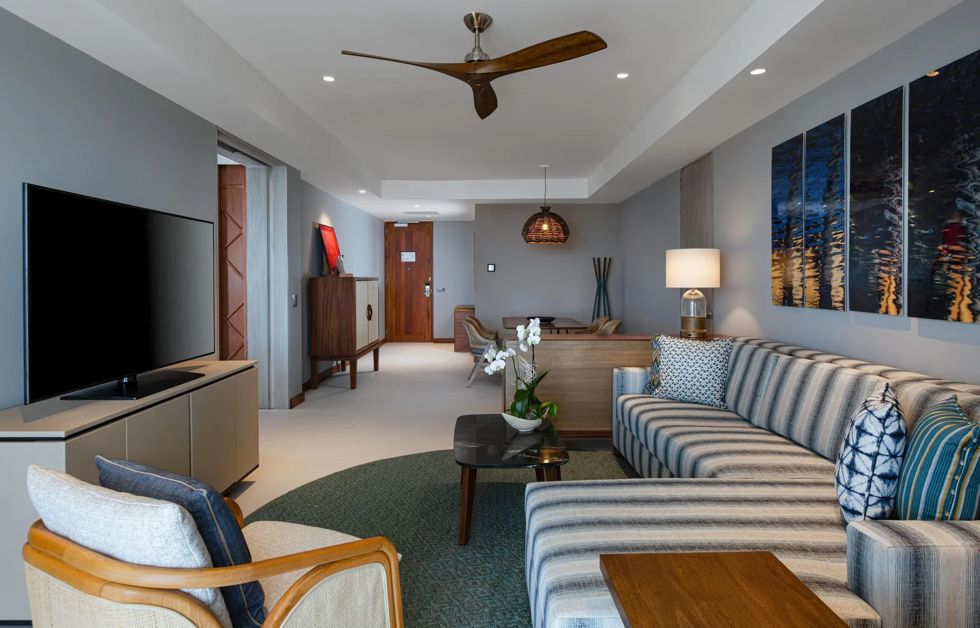 Superior Suite Ocean View living room with sectional sofa and TV at Conrad Punta de Mita.