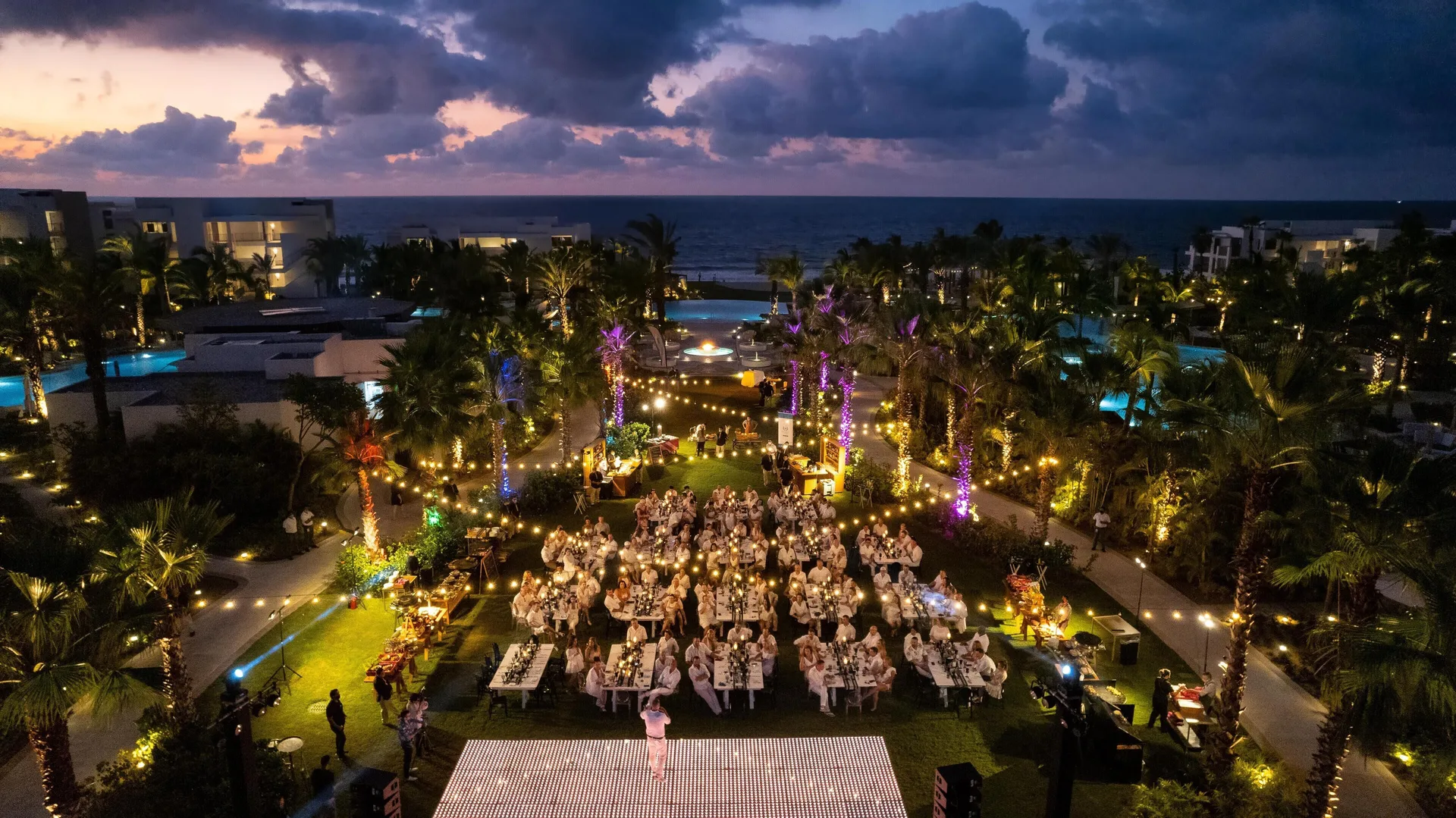 Outdoor evening event on a lawn by the ocean at Conrad Punta de Mita.