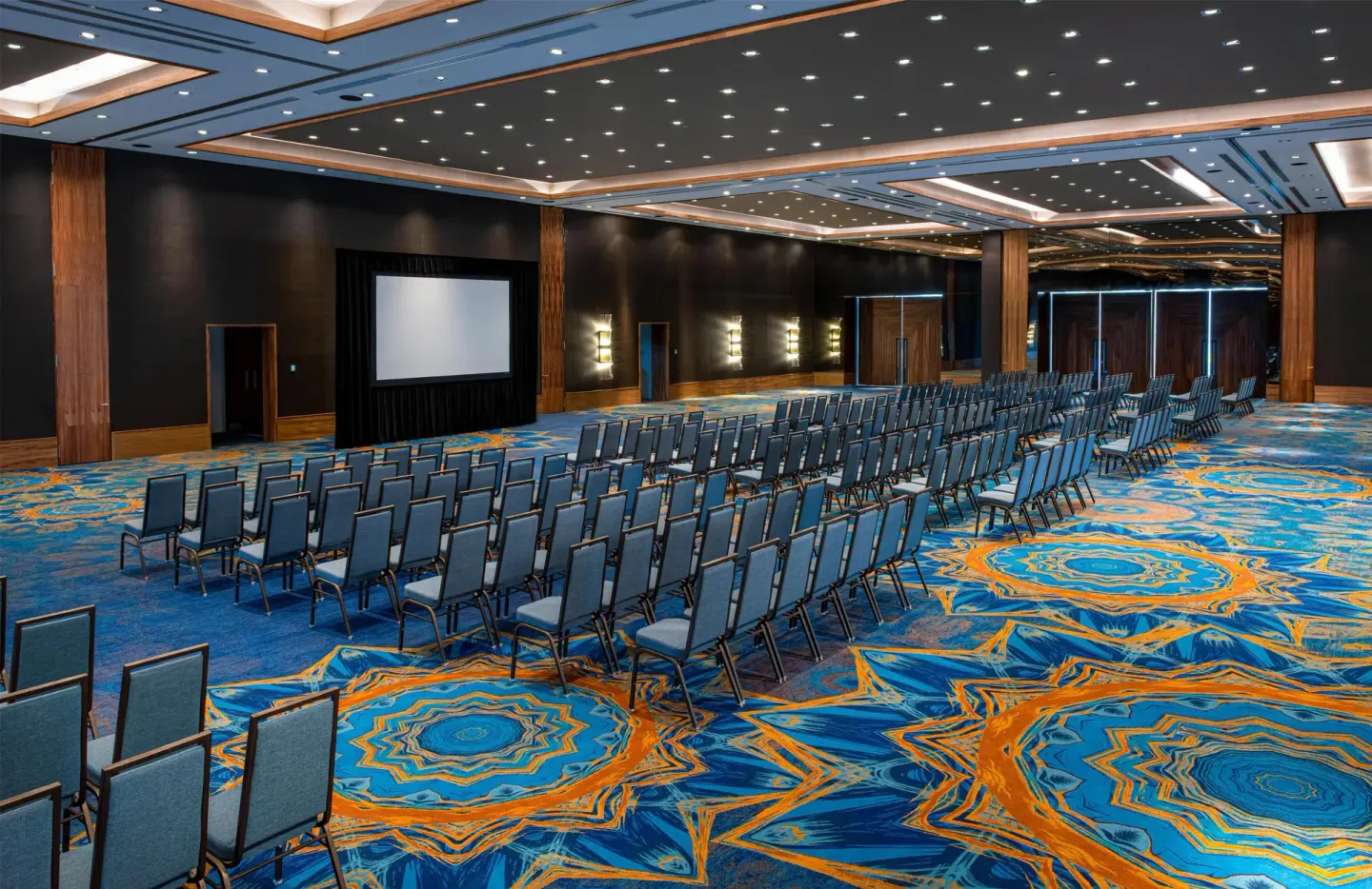 Theater-style ballroom seating and projection screen at Conrad Punta de Mita.
