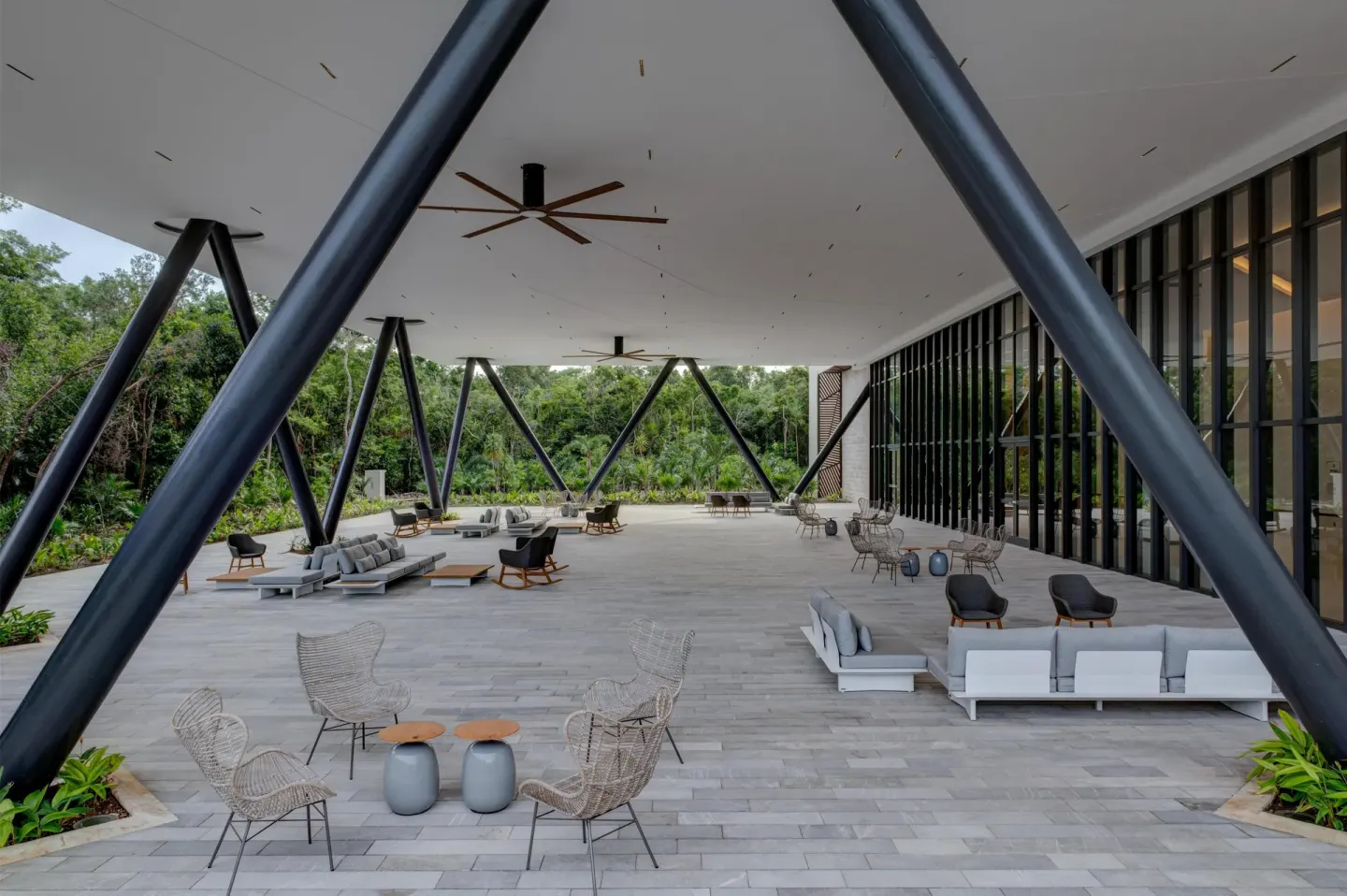 Covered outdoor terrace with lounge seating at Conrad Tulum Riviera Maya.
