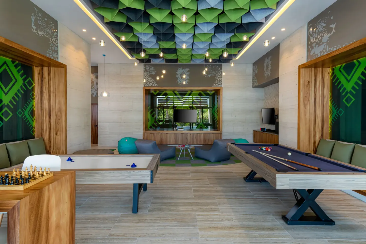 Game room with billiards, shuffleboard, chess, and lounge seating at Conrad Tulum Riviera Maya.