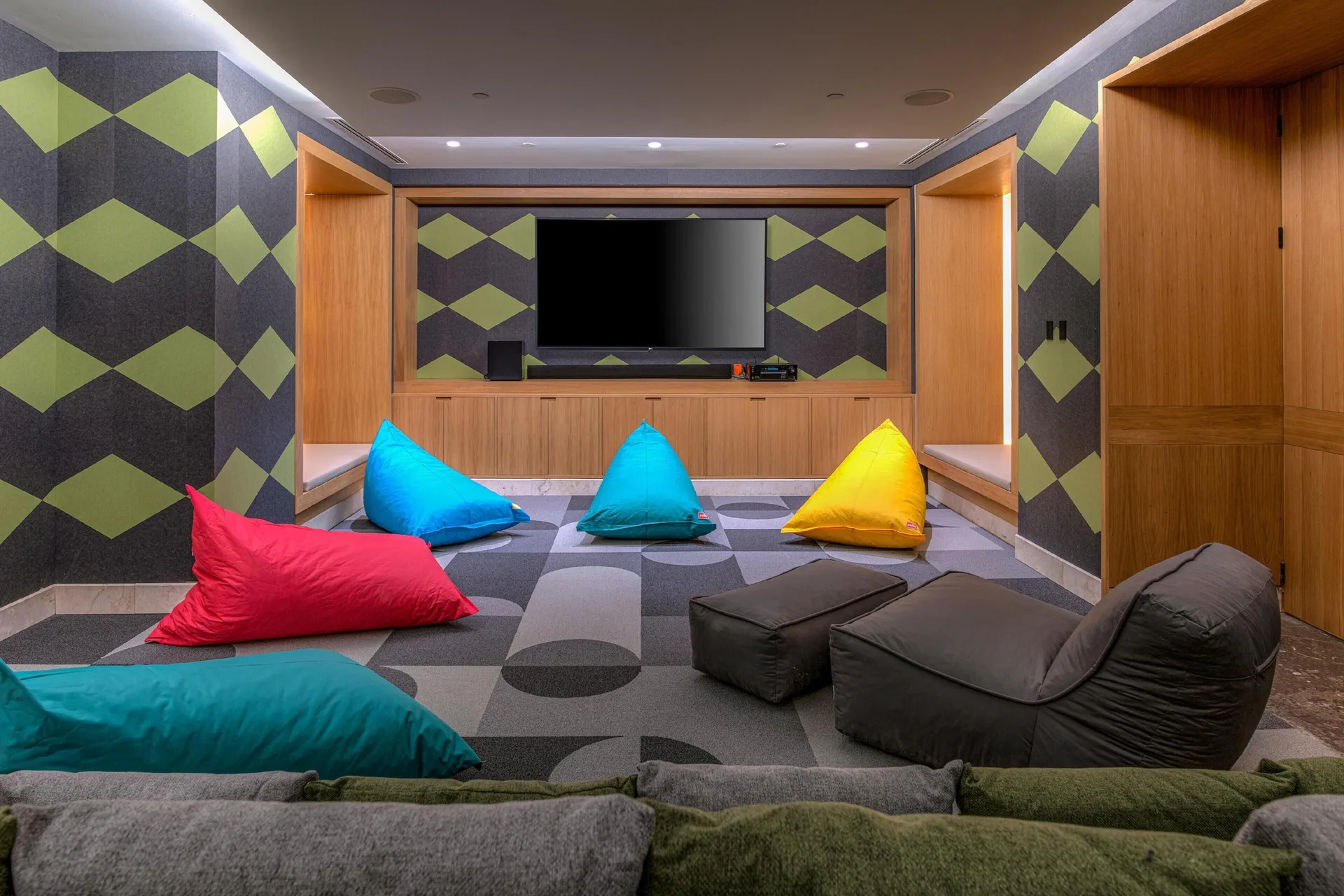 Kids lounge with colorful beanbags and a large TV at Conrad Tulum Riviera Maya.