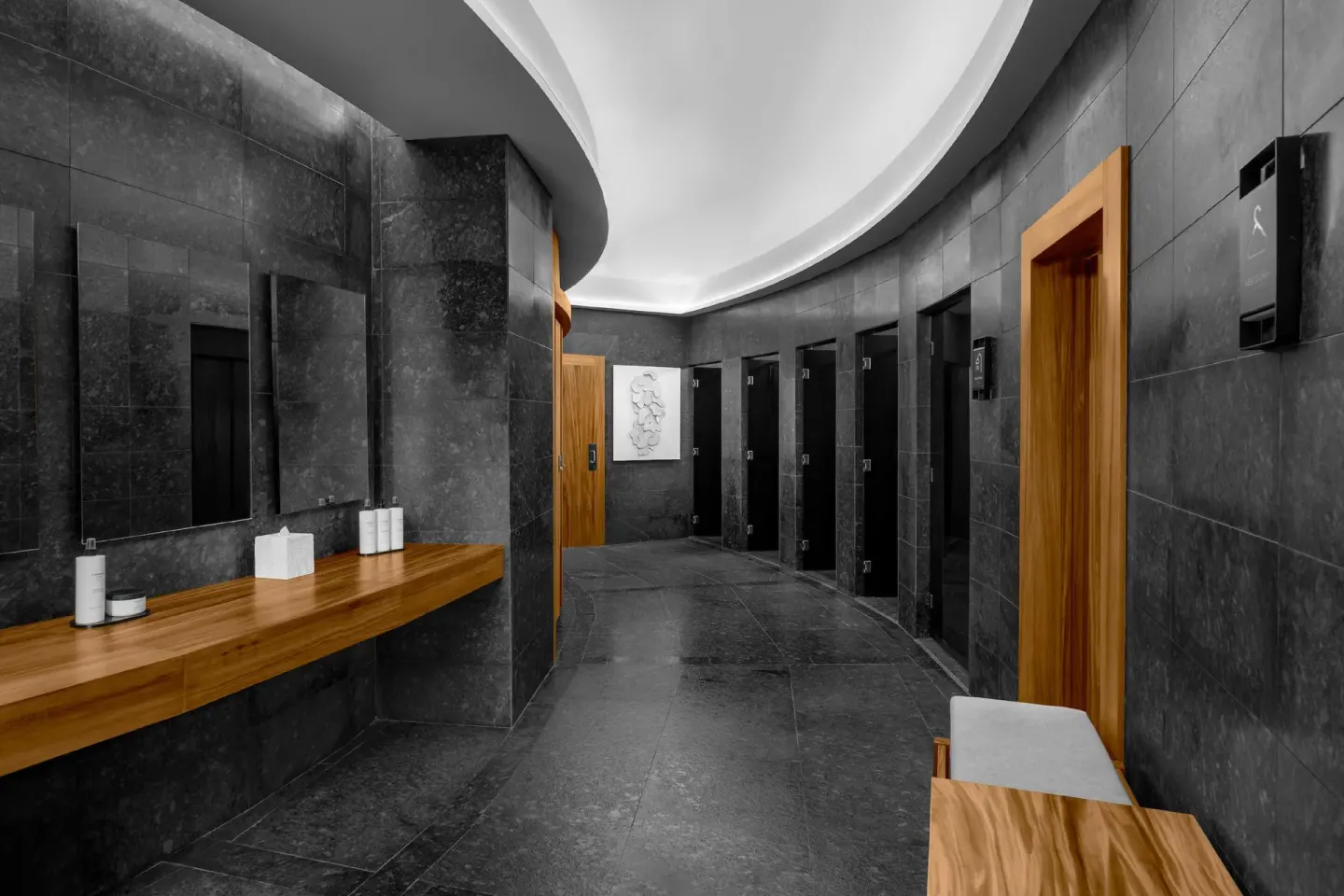 Spa locker room corridor with vanities and dark tile at Conrad Tulum Riviera Maya.