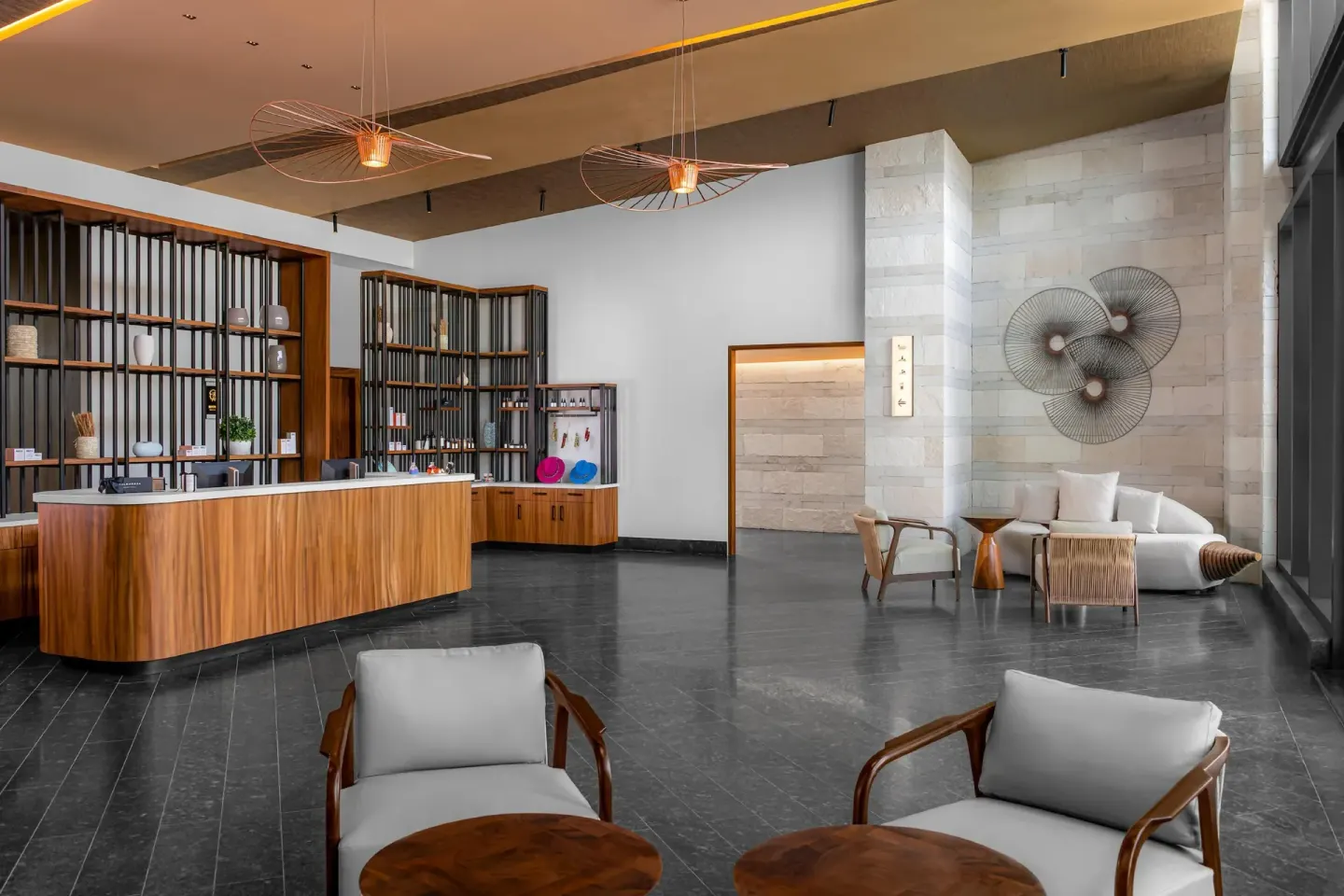 Spa reception lounge with retail displays and seating at Conrad Tulum Riviera Maya.