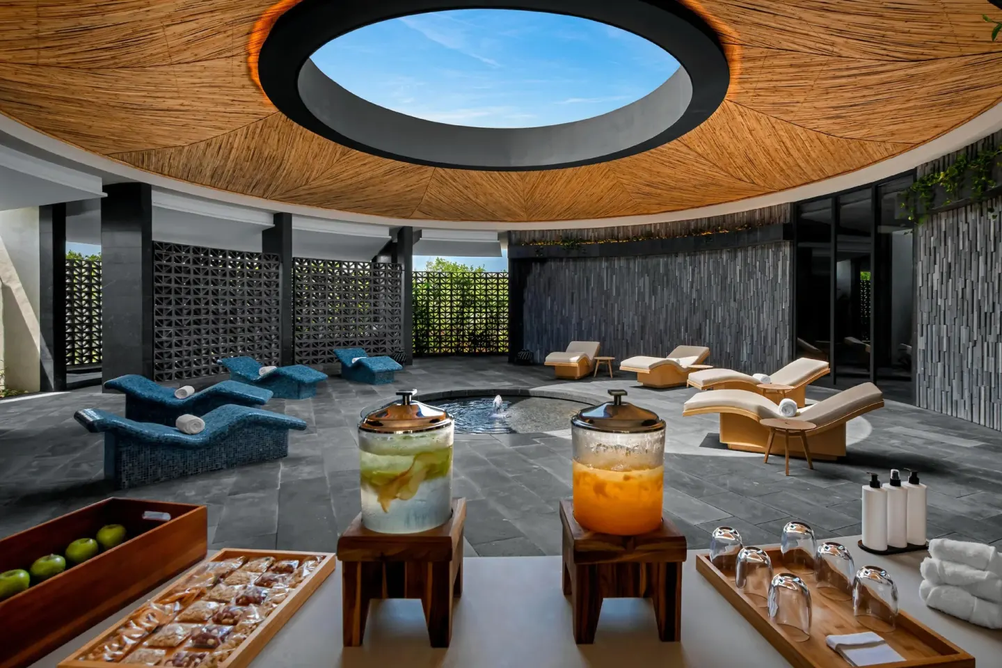 Spa refreshment station beside a skylit relaxation lounge at Conrad Tulum Riviera Maya.