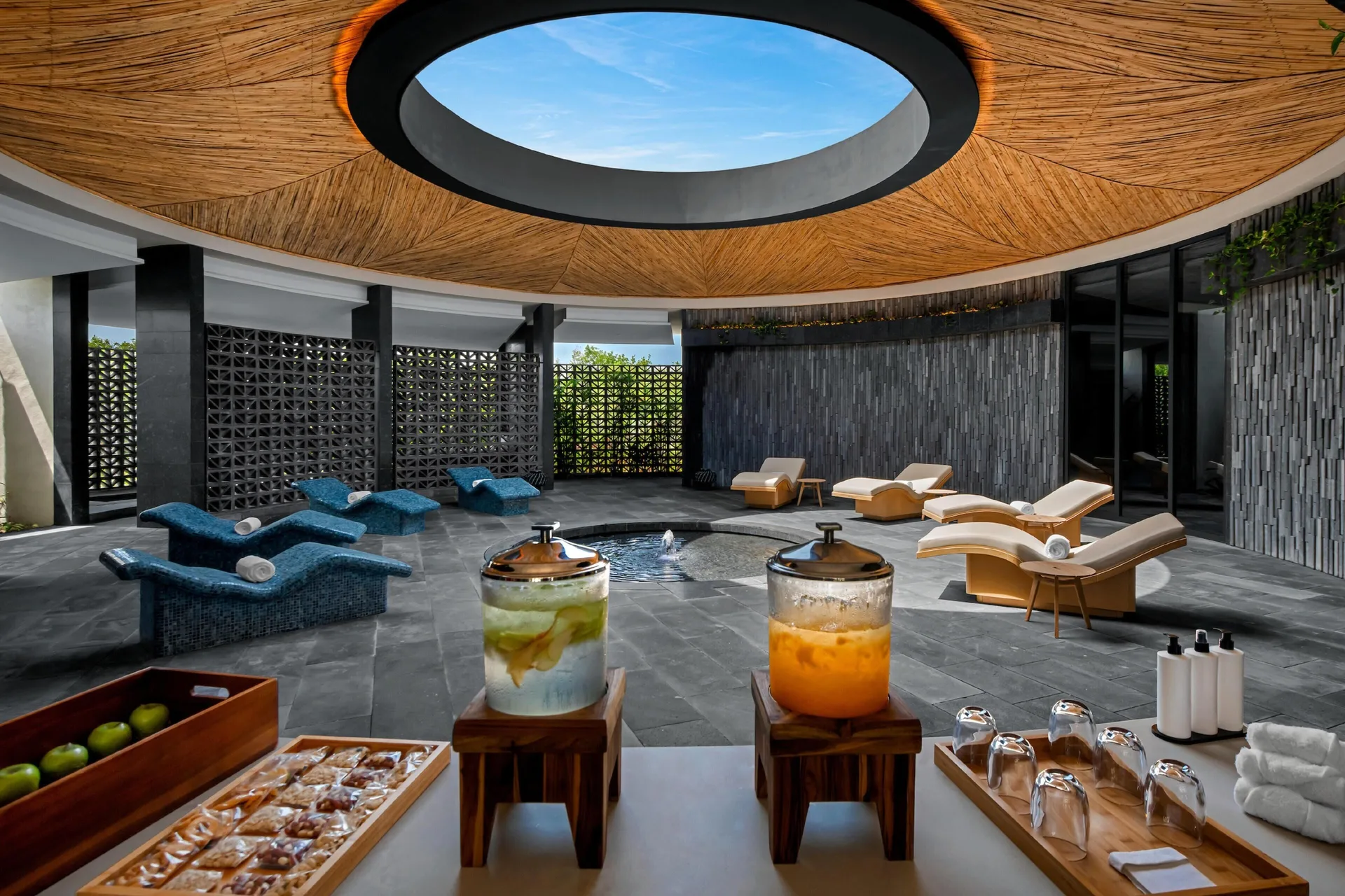 Spa refreshment station beside a skylit relaxation lounge at Conrad Tulum Riviera Maya.