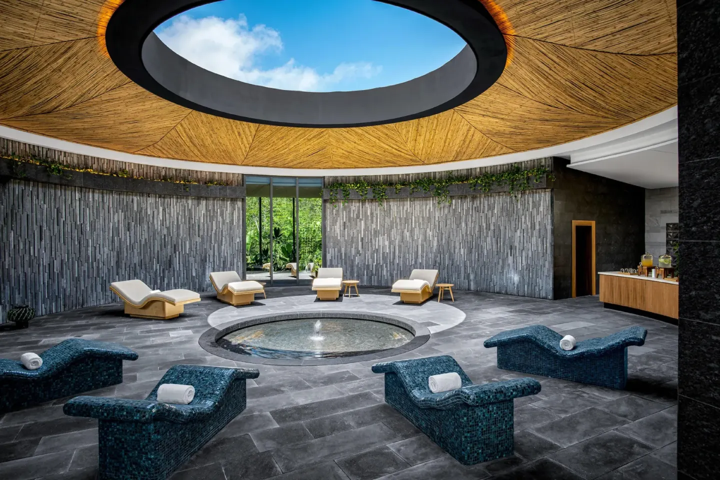 Spa relaxation area with mosaic loungers and a circular skylight at Conrad Tulum Riviera Maya.