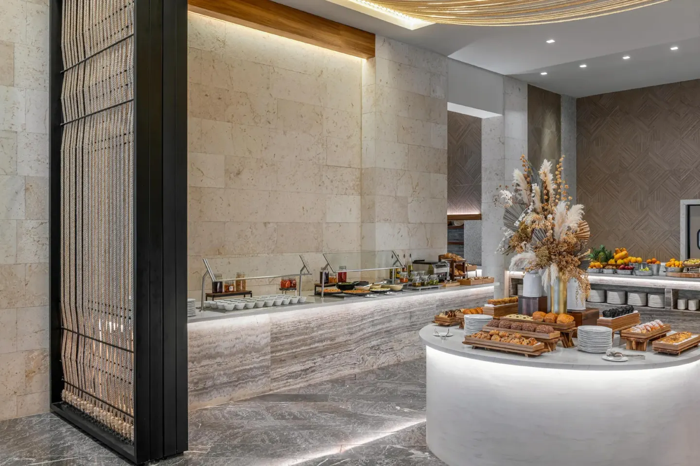 Breakfast buffet with pastries, fruit, and serving counters at Conrad Tulum Riviera Maya.