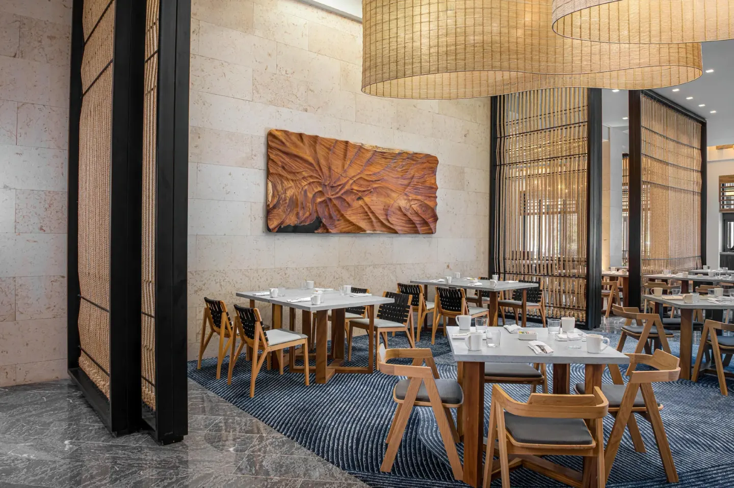 Breakfast-style dining room with wood chairs at Conrad Tulum Riviera Maya.
