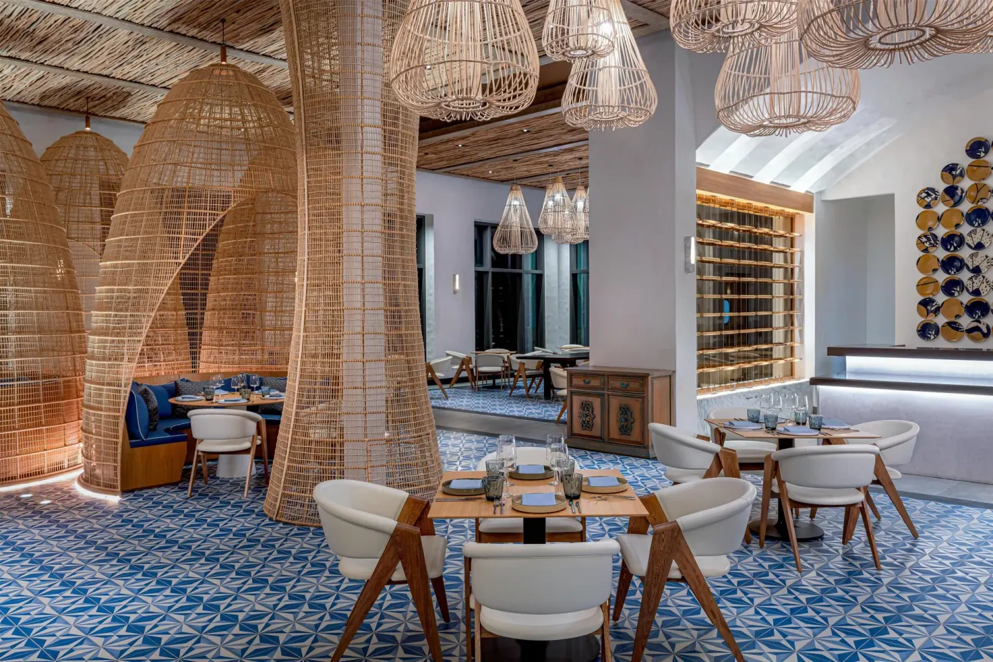 Restaurant dining room with woven basket screens at Conrad Tulum Riviera Maya.