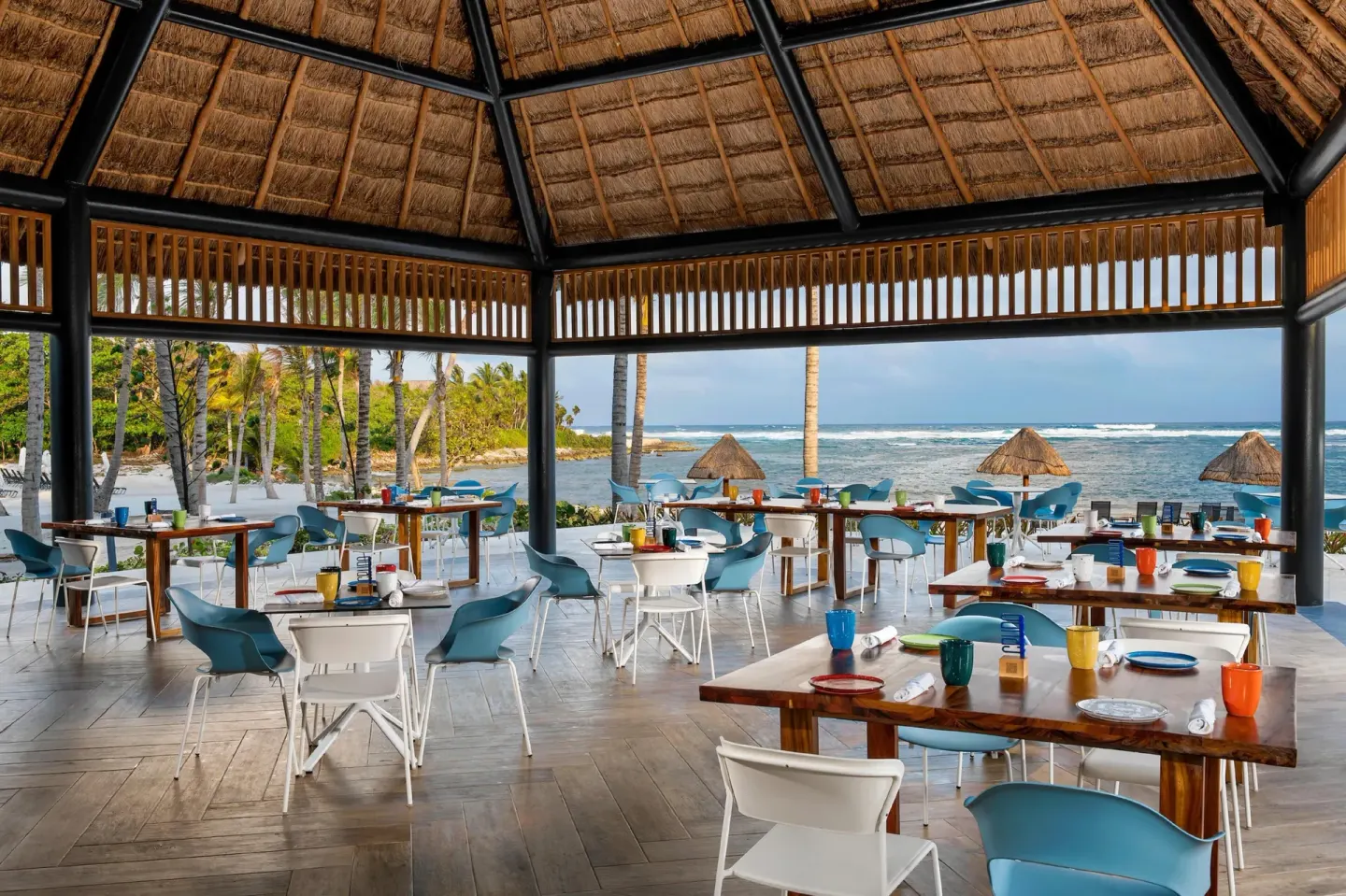 Open-air beachfront dining room with ocean views at Conrad Tulum Riviera Maya.