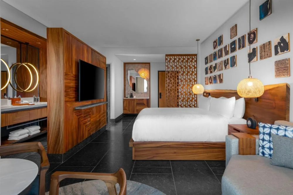 Mobility accessible king room with wood furnishings at Conrad Tulum Riviera Maya.